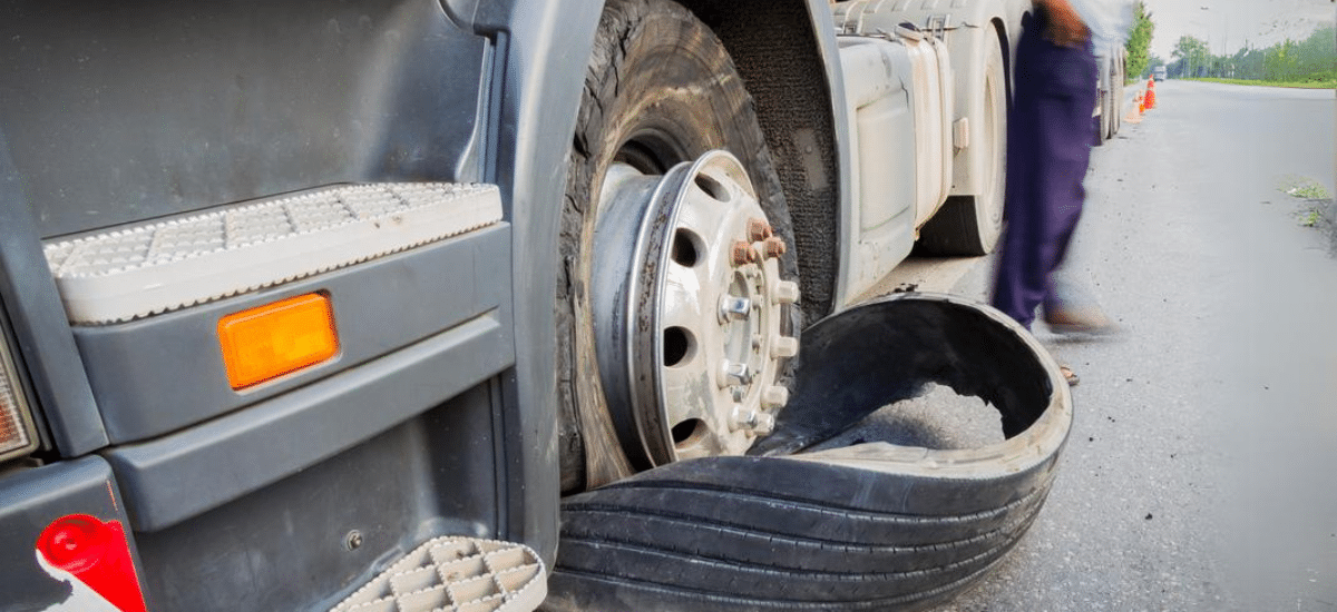 Semi-truck tire blowout repair by Hale's Automotive in Marion, IL. Image showing a semi-truck with a blown tire, emphasizing the importance of regular tire maintenance and repair services for commercial trucks to ensure safety and performance.