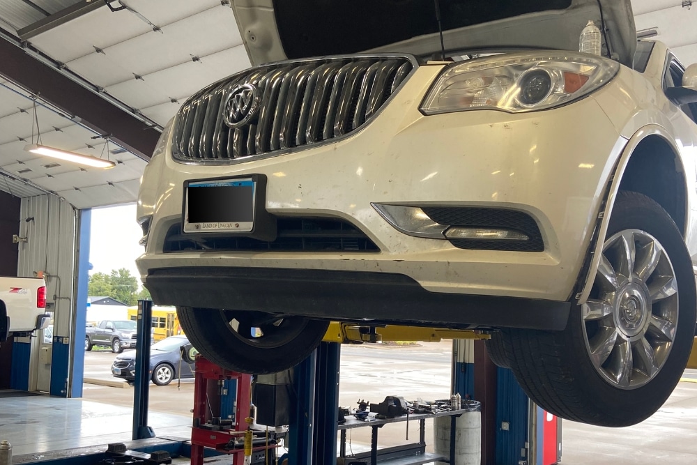 White Vehicle on lift for maintenance at Hale's Automotive in Marion, IL. Preventative Maintenance In Marion, IL At Hale's Automotive
