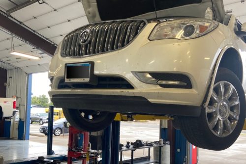 White Vehicle on lift for maintenance at Hale's Automotive in Marion, IL. Preventative Maintenance In Marion, IL At Hale's Automotive
